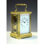 Brass carriage clock, having a white Roman dial with moon hands