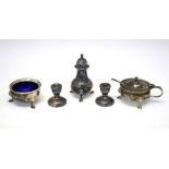 George VI silver three-piece condiment set together with a pair of dwarf candlesticks