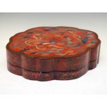 Chinese red lacquer box of oval shaped form with dragon decoration
