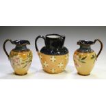 Pair of Doulton Lambeth stoneware jugs, together with a single