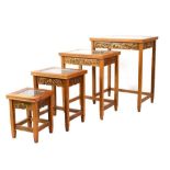 Nest of four Chinese style tables, each top having carved decoration