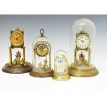 Four mid 20th Century torsion or 'Anniversary' clocks