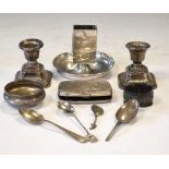 Quantity of silver items to include candlesticks, cigarette case, teaspoon, etc