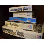 Three Tamiya model kits, plus two others