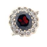 Yellow metal, garnet and white stone cluster ring,