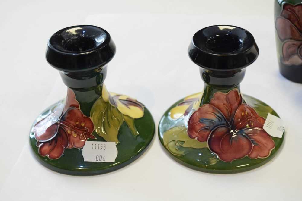 Moorcroft - Pair of Hibiscus pattern candlesticks, vase and lidded pot - Image 3 of 7