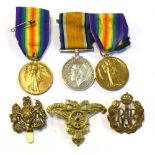 Three First World War Medals and cap badges