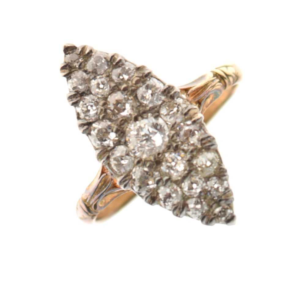 Yellow metal set marquise shaped diamond ring