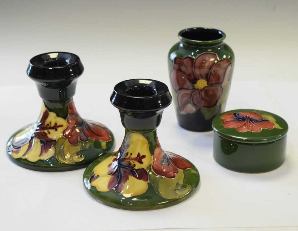 Moorcroft - Pair of Hibiscus pattern candlesticks, vase and lidded pot