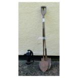 Small black painted water pump and two shovels