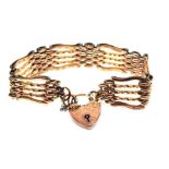 Unmarked yellow metal gate-link bracelet, with heart shaped lock