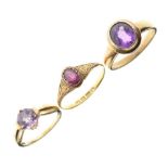 Three yellow metal dress rings set amethyst-coloured stones