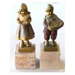 Pair of Dutch-style gilt figures on marble bases