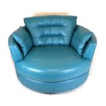Modern swivel circular snuggle sofa, upholstered in blue leatherette