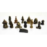 Thirteen Thai and other South East Asian miniature bronzes