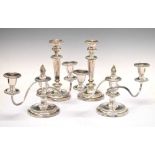 Pair of silver-plated three-light candelabra, together with a pair of en-suite candlesticks