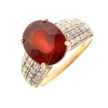 9ct gold ring set single faceted red stone and diamonds