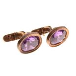 Pair of gold cufflinks with amethyst coloured stones