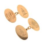 Pair of 9ct gold cufflinks engraved with hand symbol