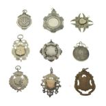 Six silver and white metal fobs