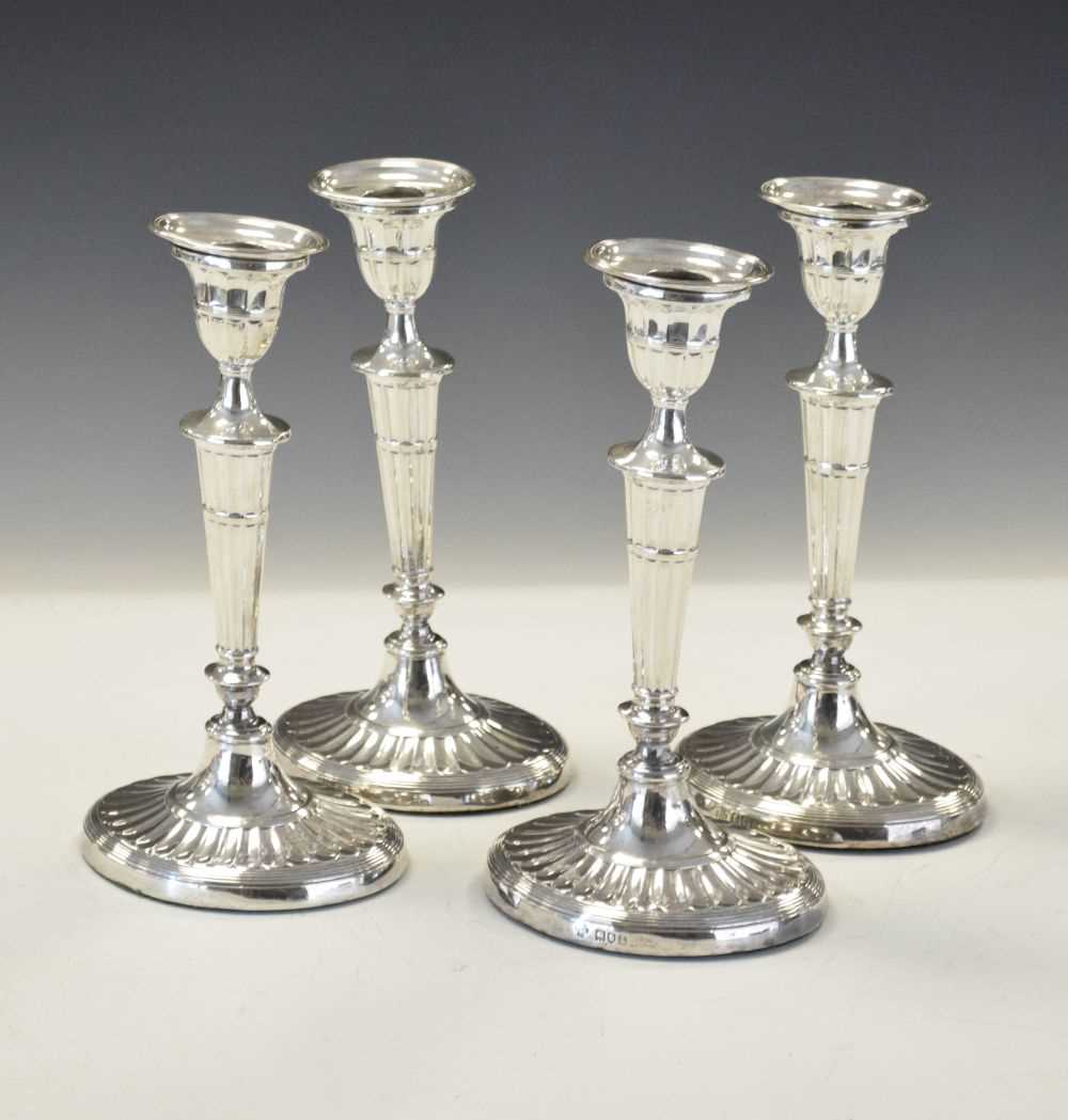 Set of four Edwardian silver Adams style candlesticks of oval form