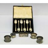 Cased set of six George V silver pattern teaspoons, together with six silver napkin rings