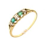 Unmarked yellow metal, emerald and diamond five stone ring