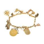 18ct gold bracelet attached various charms, and a George V half sovereign