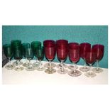 Nine cranberry-bowl wine glasses and seven emerald green