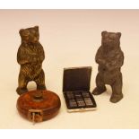 Two cast moneyboxes, cased travel dominoes, leather tape measure