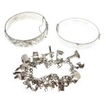 Two silver snap bangles, and a silver charm bracelet