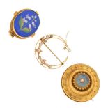 Crescent shaped brooch set seed pearls, stamped '15ct', a yellow metal target brooch, and a floral d