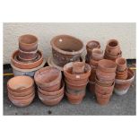 Quantity of various sized terracotta and glazed garden pots