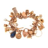9ct gold curb-link charm bracelet, attached various charms