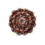 Unmarked yellow metal and garnet-coloured stone cluster ring