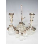 Quantity of silver to include; bud vase, candlesticks and bottles