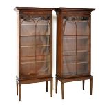 Pair of early 19th Century glazed mahogany bookcase sections on later stands