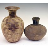 Elliptical pottery vase with raised surface decoration and black finish
