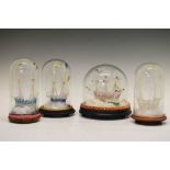 Four Victorian glass 'frigger' ships under domes