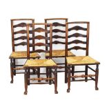 Four early 20th Century rush seated ash country ladderback chairs