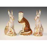 Three Royal Crown Derby figures, a pair of Midsummer Hares and Playful Otter