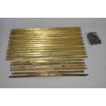 Twenty-one brass stair rods and a quantity of cups