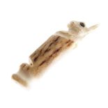 Carved stag antler whistle in the form of a rabbit or hare