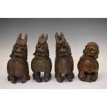 Four South East Asian carved Temple Dogs