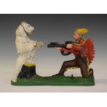 Cast iron money bank of a red Indian shooting a bear
