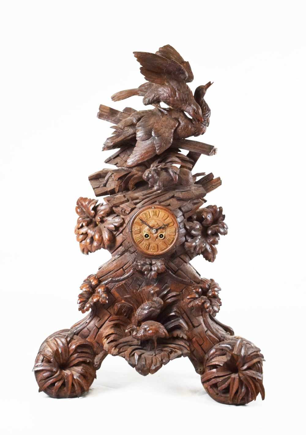 Impressive Black Forest carved linden wood table clock