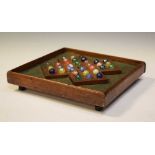 Victorian oak solitaire or 'Fox and Goose' board, and marbles