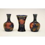 Pair of William Moorcroft 'Pomegranate' pattern vases plus another