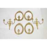 Two pairs of early 20th century gilt metal mirror sconces and gilt wall lights