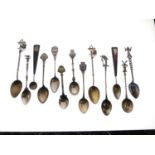 Group of white metal and unmarked souvenir spoons
